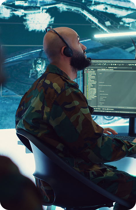 bearded man sitting at military desk
